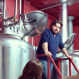 Marvin showing the fermentation tanks at Post Modern Brewery